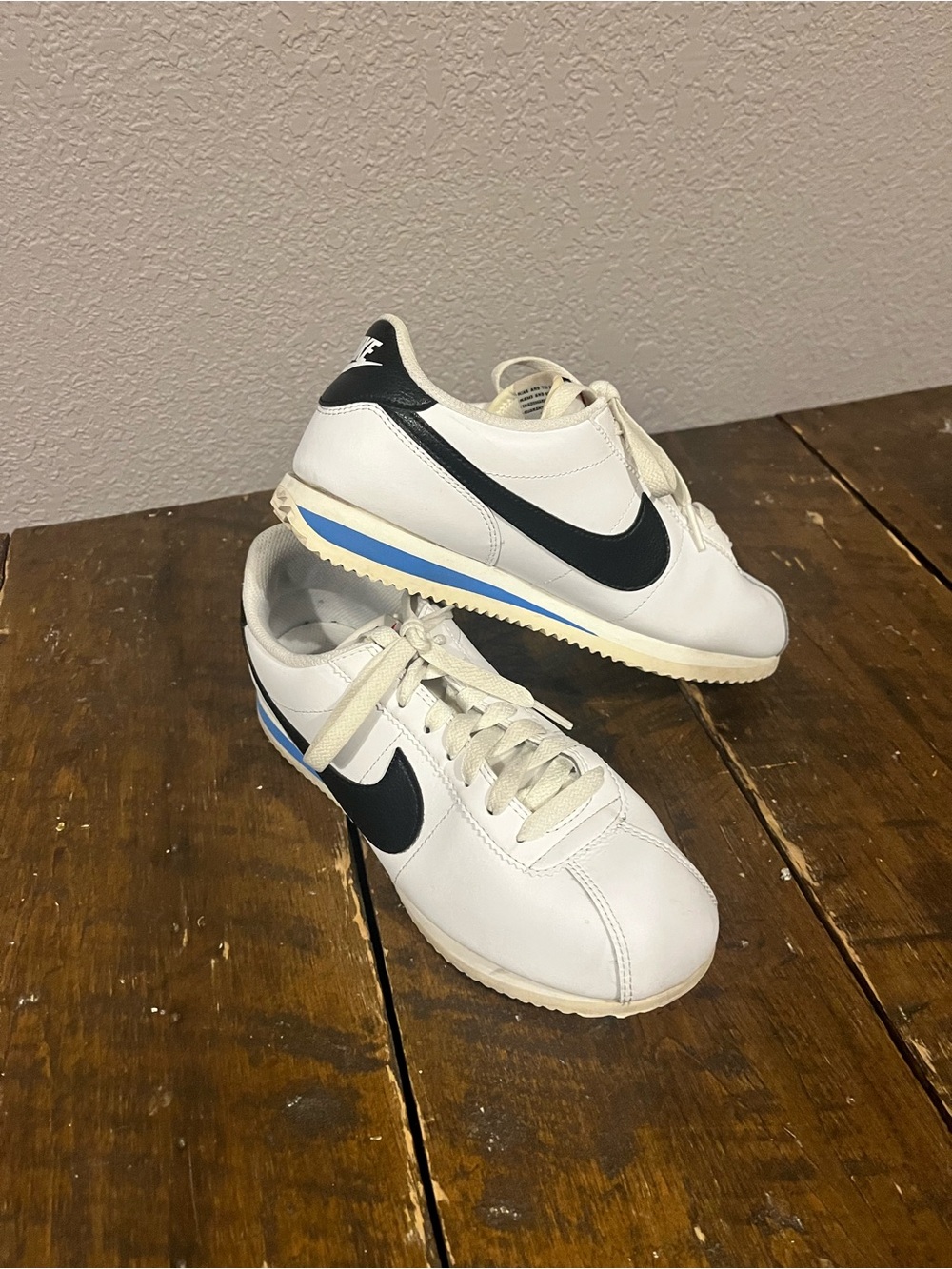 Nike White Sneakers with Black Swoosh and Blue Accent